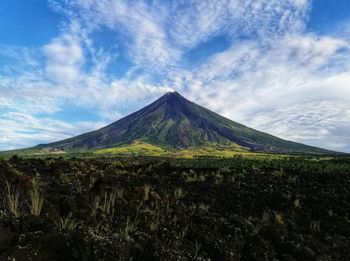 View of volcanic landscape against cloudy sky