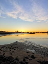 Scenic view of beach against sky during sunset