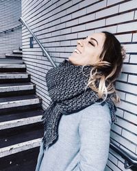 Smiling woman standing on staircase