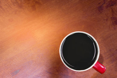 High angle view of black coffee on table