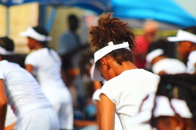 Rear view of athletes exercising outdoors