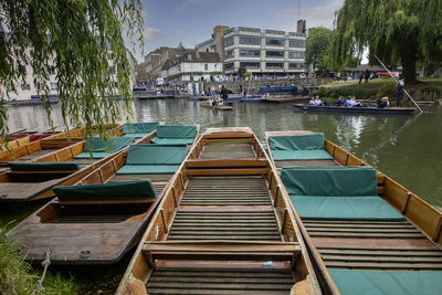 Boats moored in canal by buildings in city