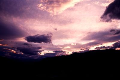 Scenic view of mountains against cloudy sky