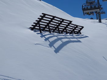 Empty chair on snow covered field