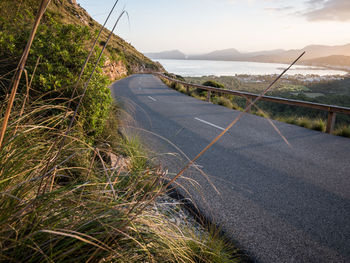 Road by sea against sky