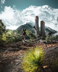 Side view of woman standing on mountain