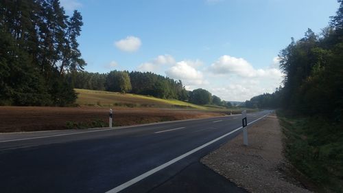 Empty road along countryside landscape