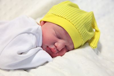 Close-up of baby sleeping on bed