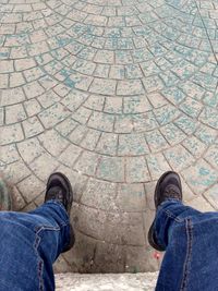 Low section of man standing on footpath