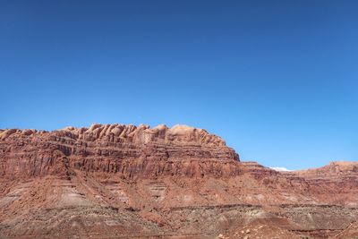 Rock formations in desert against clear blue sky