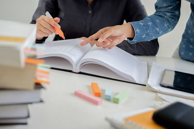 Midsection of man working on table