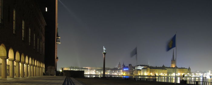 Illuminated buildings against clear sky at gamla stan