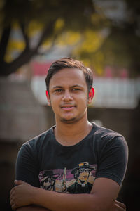 Portrait of young man sitting outdoors