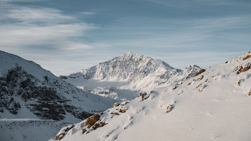 Panoramic view of snowcapped mountains against sky