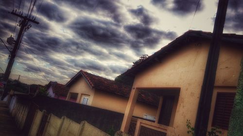 Low angle view of building against cloudy sky