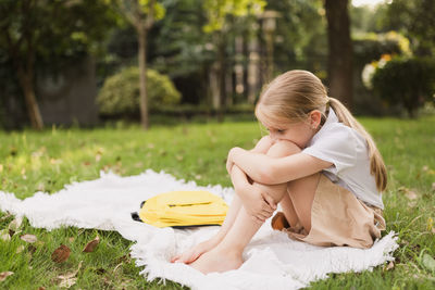 Woman sitting on field