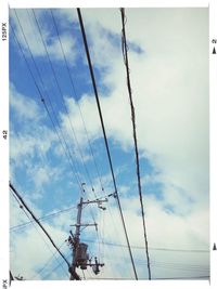 Low angle view of electricity pylon against cloudy sky