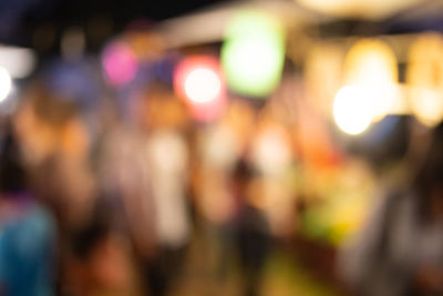 Defocused image of people at night