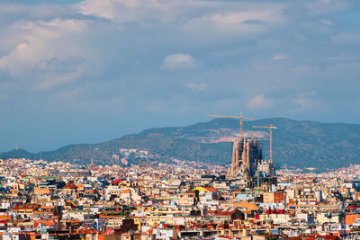 Aerial view of barcelona city with famous sagrada familia basilica under construction