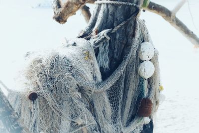 Close-up of fishing net on wooden post