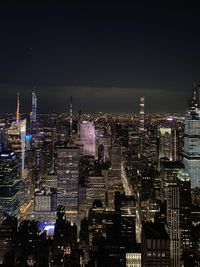 High angle view of illuminated city buildings against sky