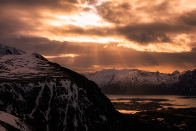 Scenic view of snowcapped mountains against sky during sunset