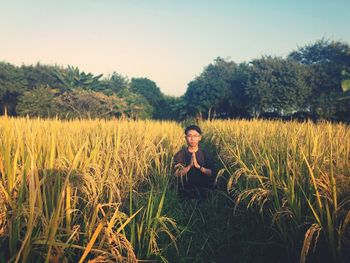 Man standing on field against sky