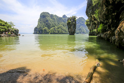 Scenic view of rocks in sea against sky