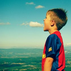 Portrait of boy at beach against sky