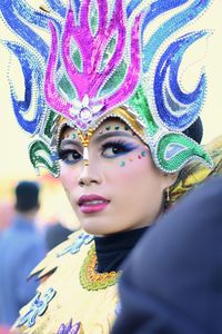 Portrait of beautiful woman wearing venetian make-up at carnival