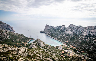 High angle view of rocky coastline against sky