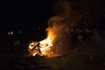 People on fire at night