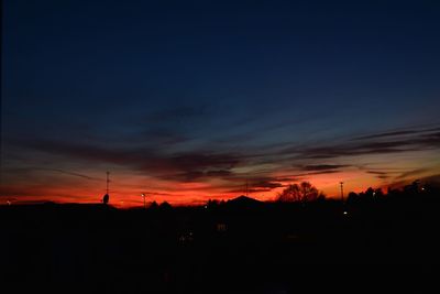 Scenic view of silhouette city against sky during sunset