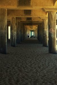 Woman walking in corridor of historic building