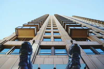 Low angle view of tall building against clear sky