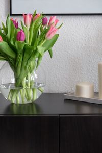 Tulips in vase on table at home