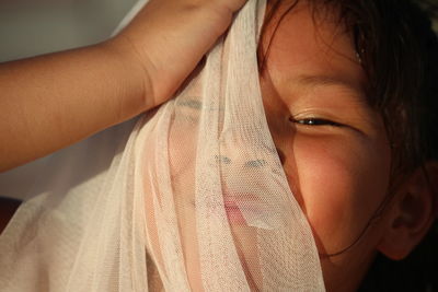 Close-up portrait of girl holding scarf