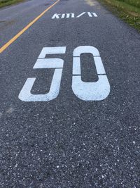 High angle view of number 50 on road