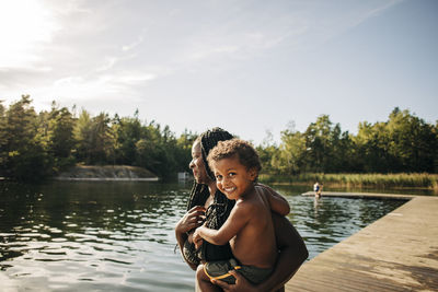 Portrait of happy boy in mother arms during vacation