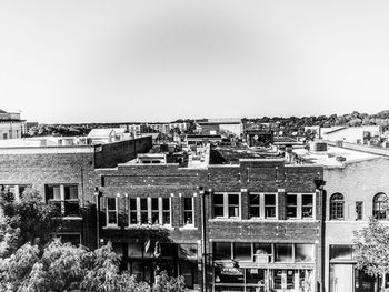 High angle view of buildings by river against clear sky