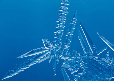 Close-up of frozen sea against blue background