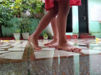 Low section of woman standing on table