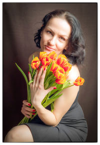 Close-up of young woman holding flower