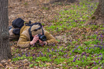 Midsection of man photographing outdoors