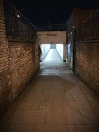 Empty footpath amidst buildings