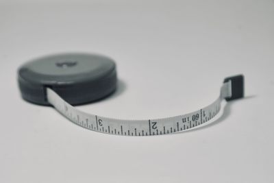 High angle view of eyeglasses on table against white background