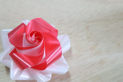 Close-up of red rose on table