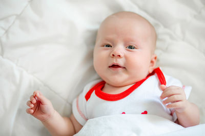 Portrait of cute baby girl sleeping on bed