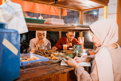 Rear view of woman preparing food on table