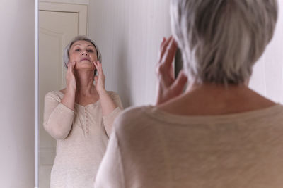 Rear view of woman in bathroom